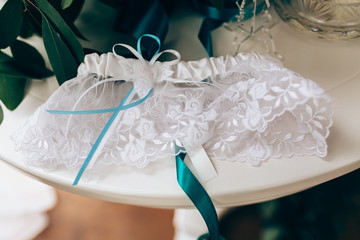 Wedding accessories: Bride's garter and delicate  bow. Closeup