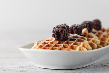 Brussels waffles with blackberries on plate