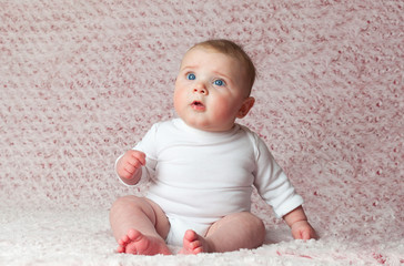 Newborn baby girl with white bodysuit