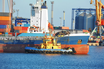 Tugboat assisting bulk cargo ship