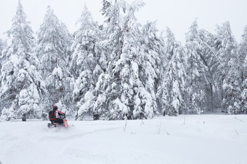 Winter Finnish snowy lanscape with road and snowmobile