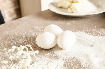 Fototapeta na wymiar Beautiful picture of white eggs on table with floure in kitchen