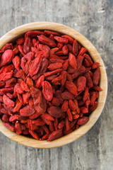Wolfberries or Goji berries in bowl on wooden table
