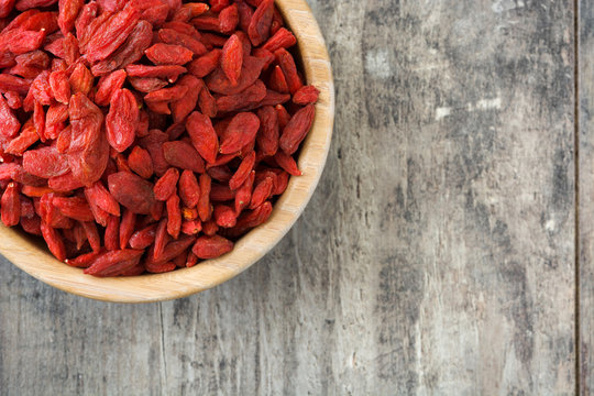 Wolfberries or Goji berries in bowl on wooden table
