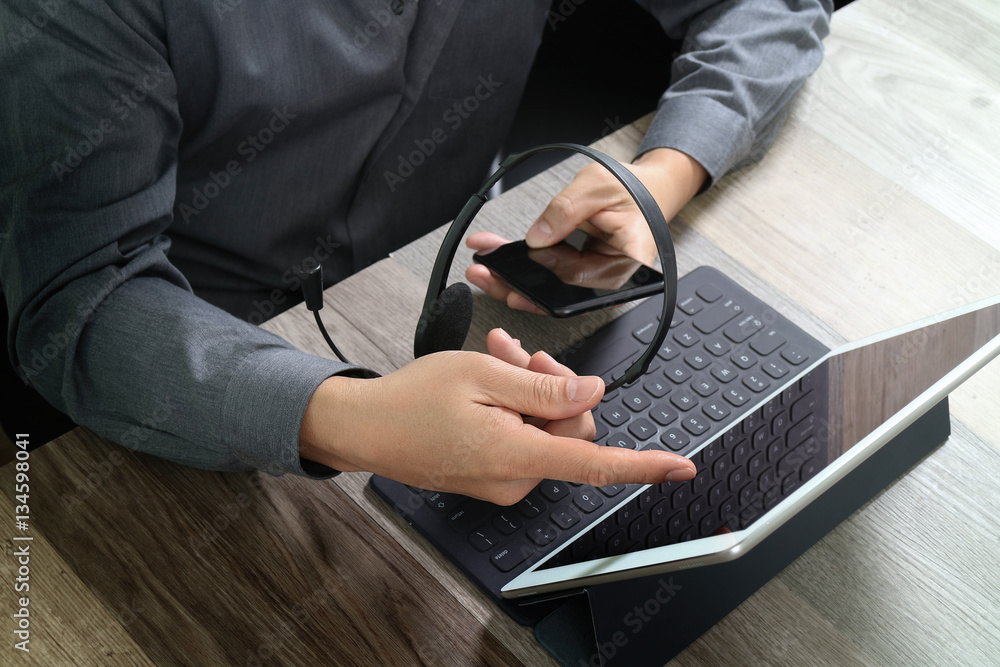 Aufkleber top view of man hand using VOIP headset with digital tablet comp