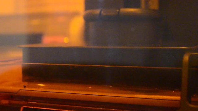 Stereolithography DPL 3d printer create detail and liquid drips, platform slowly move with liquid close-up. Progressive modern additive technology 3D printing, create scaled model by UV polymerization