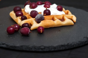 homemade Belgian waffles with berries, whipped cream