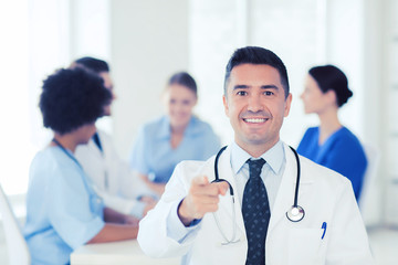 happy doctor over group of medics at hospital