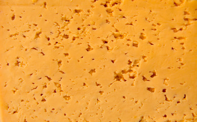 Texture of a fresh yellow cheese