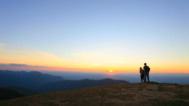 man and woman trekking on high mountain
