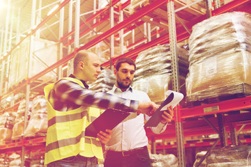 worker and businessmen with clipboard at warehouse