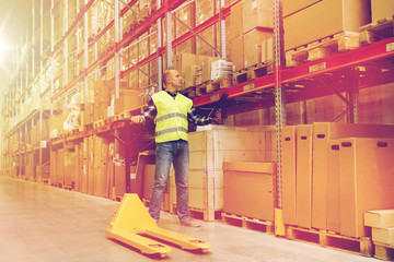 man with loader and clipboard at warehouse