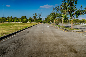 Asphalt road with arrow sign and white dot line