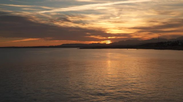 Sea sunset. On the horizon are visible mountains.