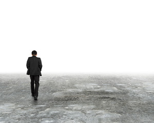Man walking in mist on dirty concrete floor