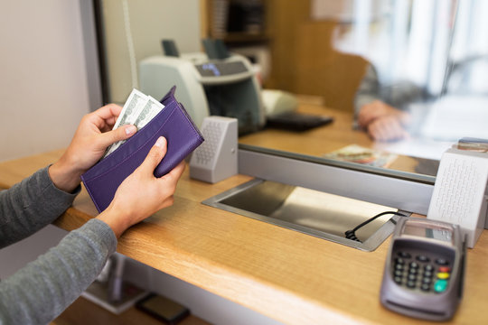 hands with money at bank or currency exchanger