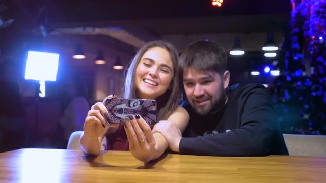Young Happy Smiling Couple doing Selfie with Mobile Phone. HD.