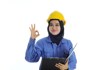 Construction worker wear yellow safety helmet show okay sign while holding a file