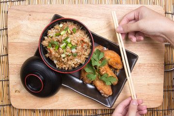 Fried chicken wings served with fry rice