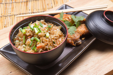 Fried chicken wings served with fry rice