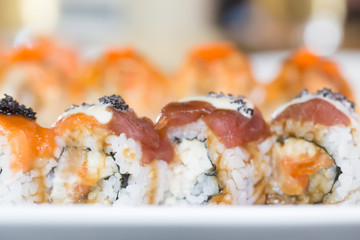 Salmon sushi roll on white plate