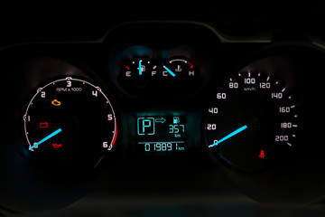 Closeup of a tachometer and speedometer on a sports car dashboard