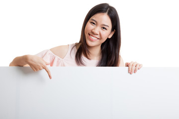 Young Asian woman point to a  blank sign.