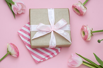 Gift for Valentines day with flowers on the pink background