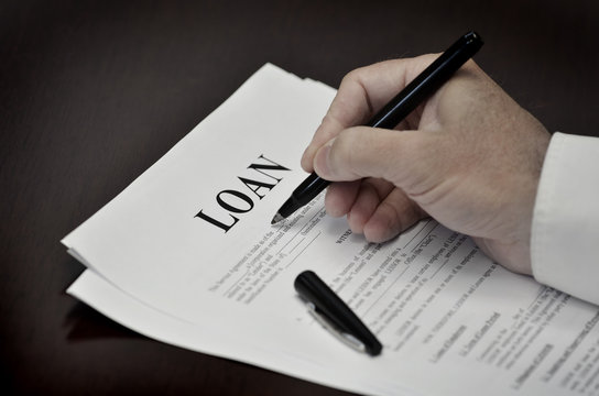 Loan Contract Document on Desk with Black Pen