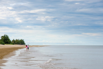 Couple Lovers walking on the sea beach with copy space for label text