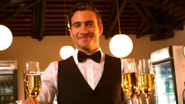 Male waiter serving a glass of champagne