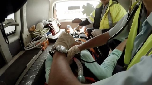 Paramedic using an external defibrillator 