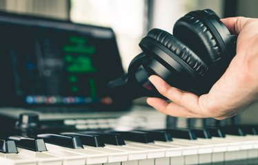 Sound engineer holding Studio headphone in home studio