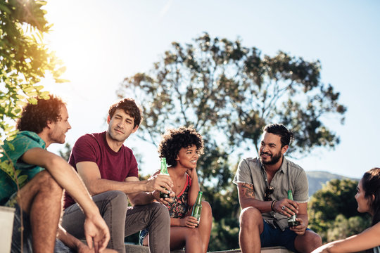 Group of friend hanging out on outdoor party