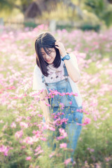 girl is smiling in pink cosmos flower field