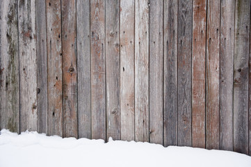 Old wooden fence, covered with snow