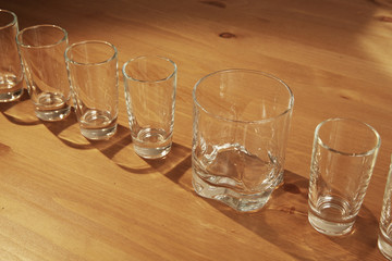 Set of small shot glasses with a whiskey glass for a difference concept