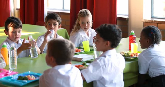Kids having meal in school cafeteria 4k
