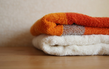 Close view of orange and white towels on a table
