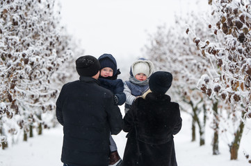 Family portrait in the winter park.