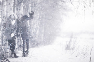 Fototapeta na wymiar Group of a stylish young girlfriends walking outdoors in winter
