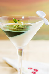 panna cotta with mint syrup and fresh leaves