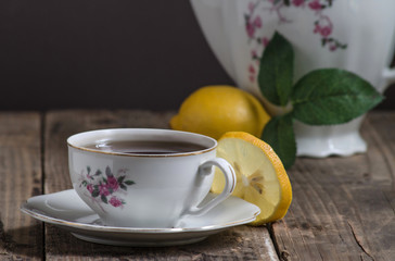 Cup of tea , teapot , and lemon