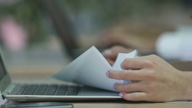 Female hands holding papers, company employee processing data in documents