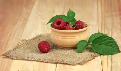Delicious raspberries on wooden background. Fresh berries.
