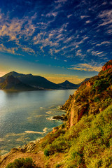 South Africa Hout Bay Cape Town golden hour scenic sunset ocean panorama, peaceful,romantic panoramic landscape and seascape with calm sea, mountains and a blue sky with clouds,harmony - obrazy, fototapety, plakaty