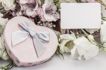 Heart shaped gift box and flowers with a name tag