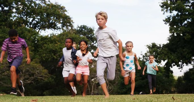 Group of children playing in park on sunny day 4k