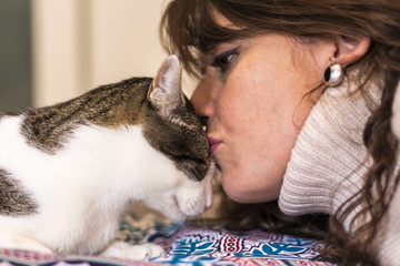 Happy woman kisses her cat