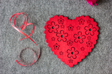 Big red heart on grey background.